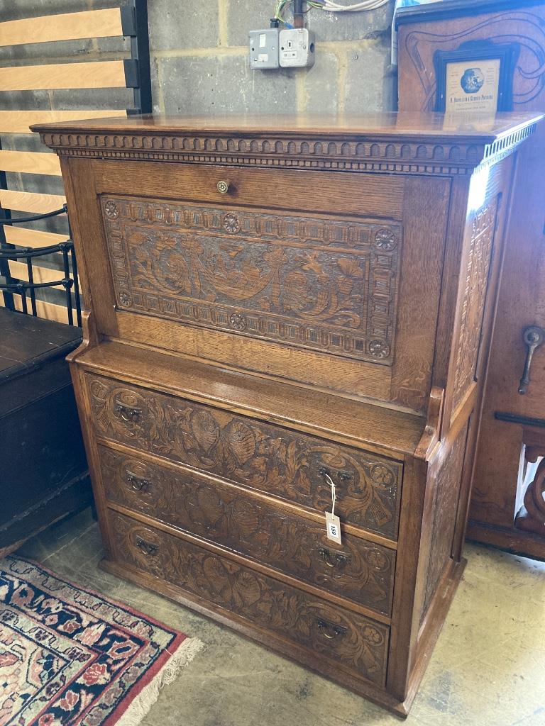 An Arts & Crafts oak escritoire, the cabinet was made out of oak shaft of the Taplow Court Mill Wheel (1845-1902) and presented by Edward Lodge in 1911, width 98cm, depth 52cm, height 122cm